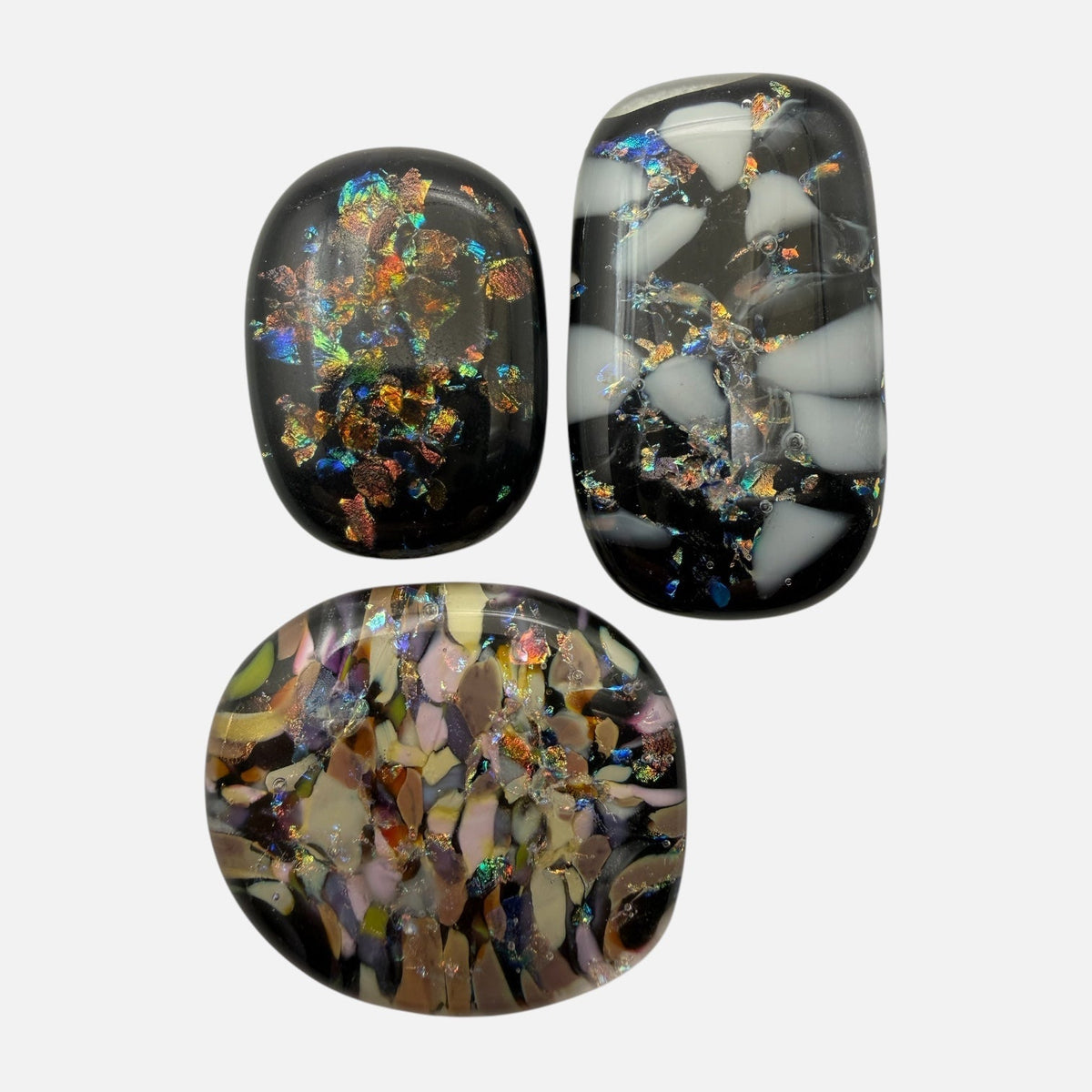 SunshineBeads trio of handmade COE90 fused dichroic glass cabochons with black bases and iridescent mosaic accents.
