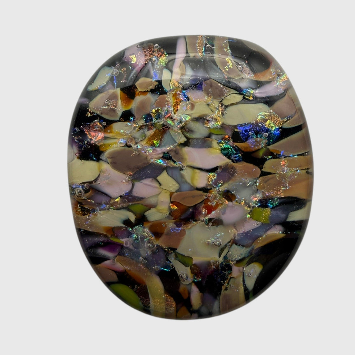 SunshineBeads handmade fused dichroic glass cabochon with a mosaic pattern of iridescent green, blue, and gold flakes.